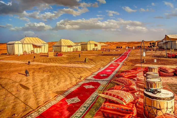 Camel caravan crossing the Erg Chebbi dunes at sunset on a luxury Morocco tour package, Merzouga, Morocco